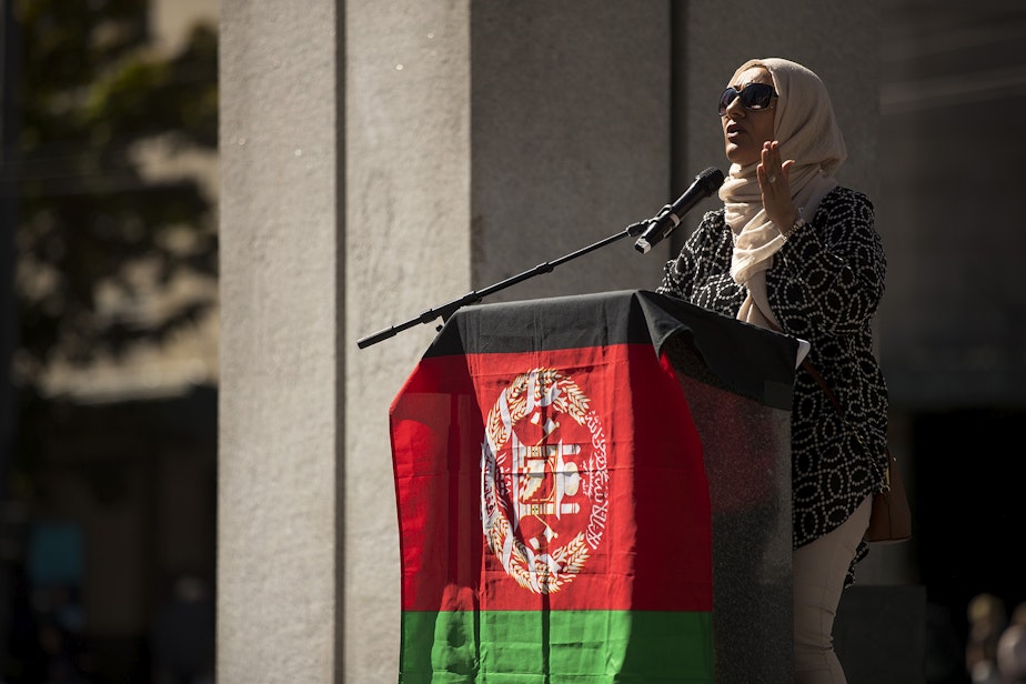 caption: Zarby Kakar speaks to a crowd of about 100 people standing in solidarity with Afghans on Saturday, August 28, 2021, at Westlake Park in Seattle. "We can never stop fighting for our people," said Kakar. "I remember as a refugee coming into this country, the greatest medicine that my mother and I received was meeting another Afghan. Do not forget your people," said Kakar. "Welcome them with open arms."