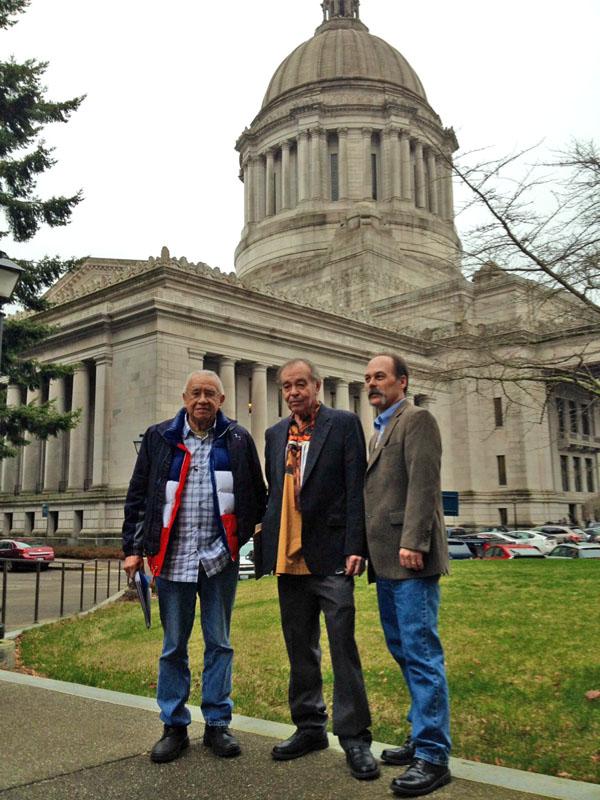 caption: Billy Frank, Jr., a veteran of the fish wars, Hank Adams, a tribal advocate, and Shawn Yanity, chairman of the Stillaguamish Tribe confer in Olympia in January.