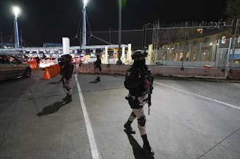 caption: Mexican National Guards patrol among the lanes of cars entering the San Ysidro Port of Entry in Tijuana, Mexico, May 11, 2023. Montserrat Caballero, the mayor of the Mexican border city of Tijuana, said on June 12, 2023 she has decided to go live at an army base for her own safety, after she received threats.