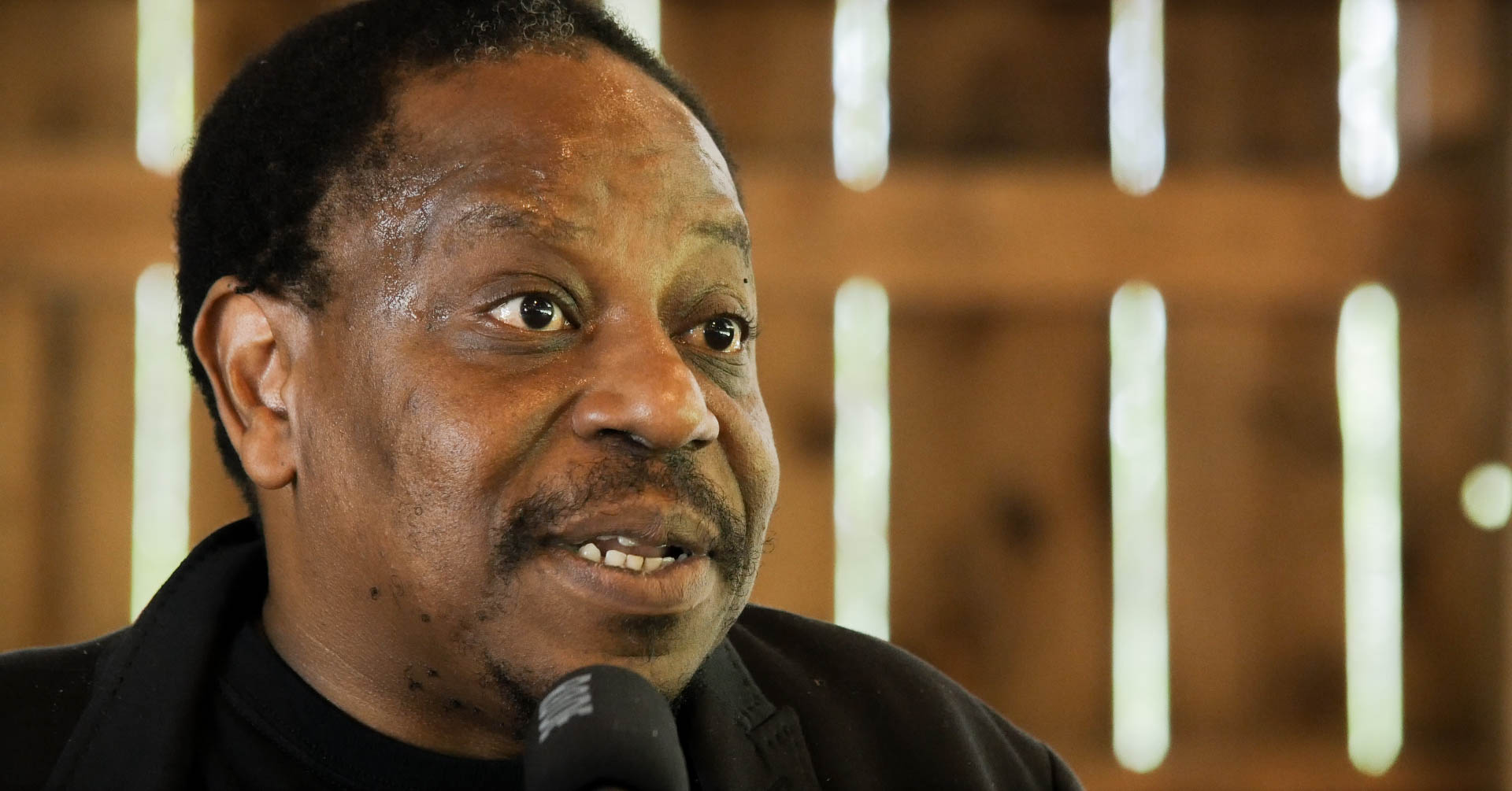 caption: Writer Charles Mudede at Smoke Farm.