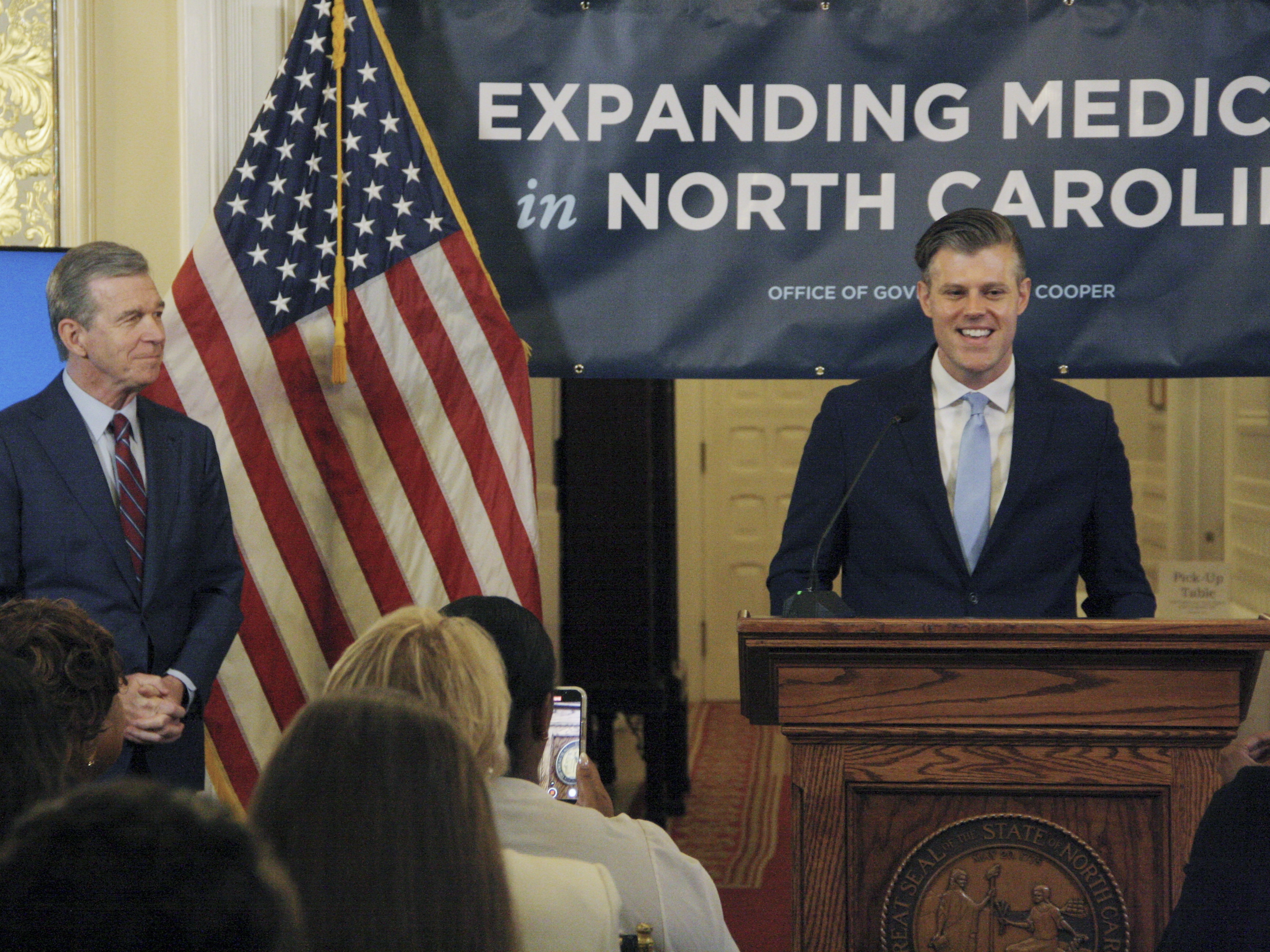 caption: North Carolina Department of Health and Human Services secretary Kody Kinsley discusses the impact of Medicaid expansion on prescriptions during a news conference at the North Carolina Executive Mansion in Raleigh, N.C., on Friday, July 12, 2024. When the state expanded access to Medicaid in December,  more than 500,000 residents gained access to health coverage. 