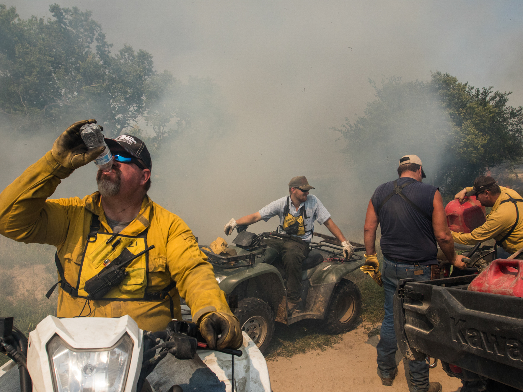 caption: Members of a landowner-led prescribed burn association work together in south-central Nebraska to complete a 945-acre prescribed burn. Everyone on the burn performs an essential role, from the four-wheeler riding internal ignition team to the mop-up crew that patrols the perimeter with water tanks strapped to flatbed pickup trucks.