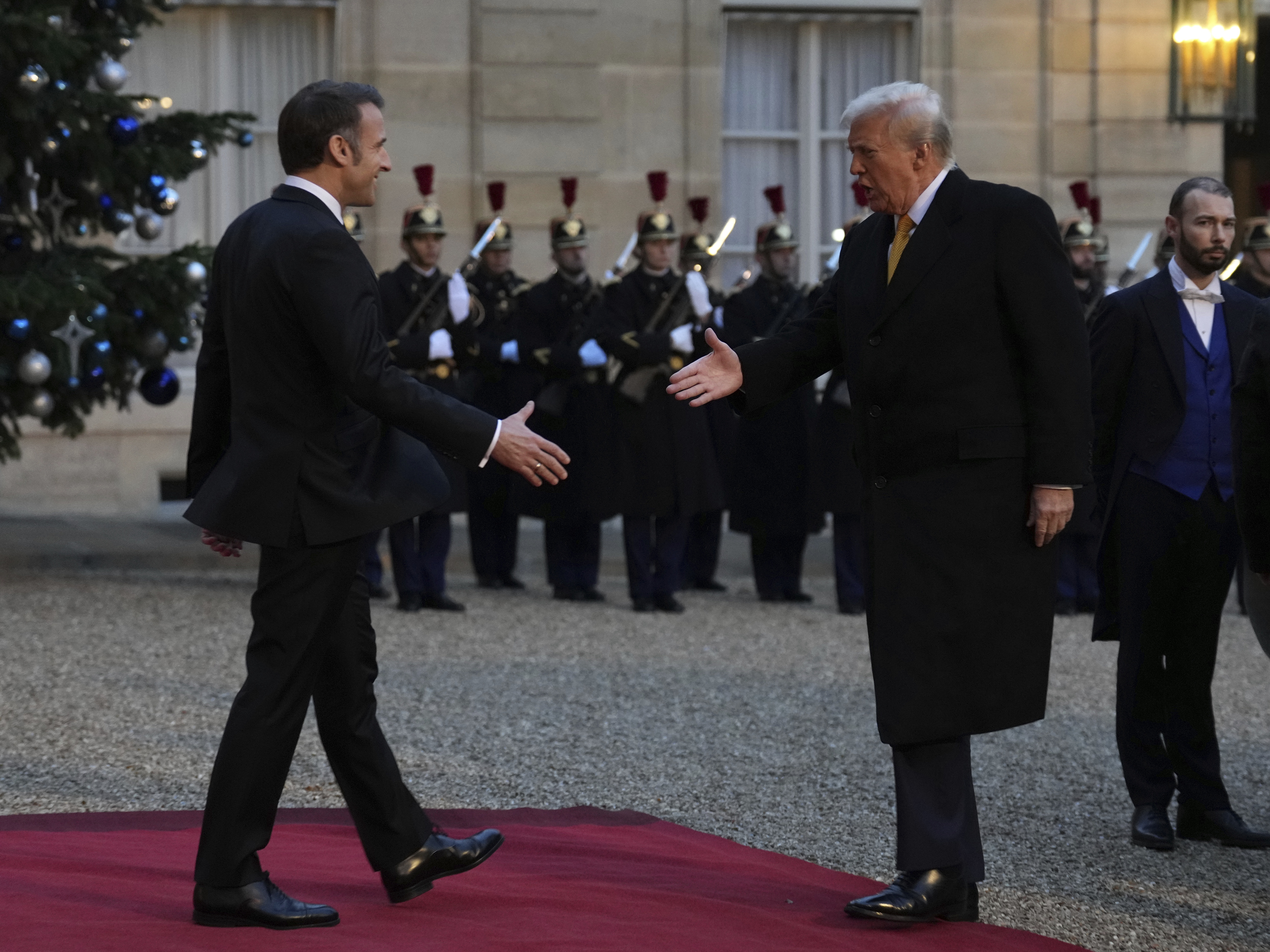 caption: French President Emmanuel Macron, left, is to shake hands with President-elect Donald Trump as he arrives at the Elysee Palace, on Saturday.
