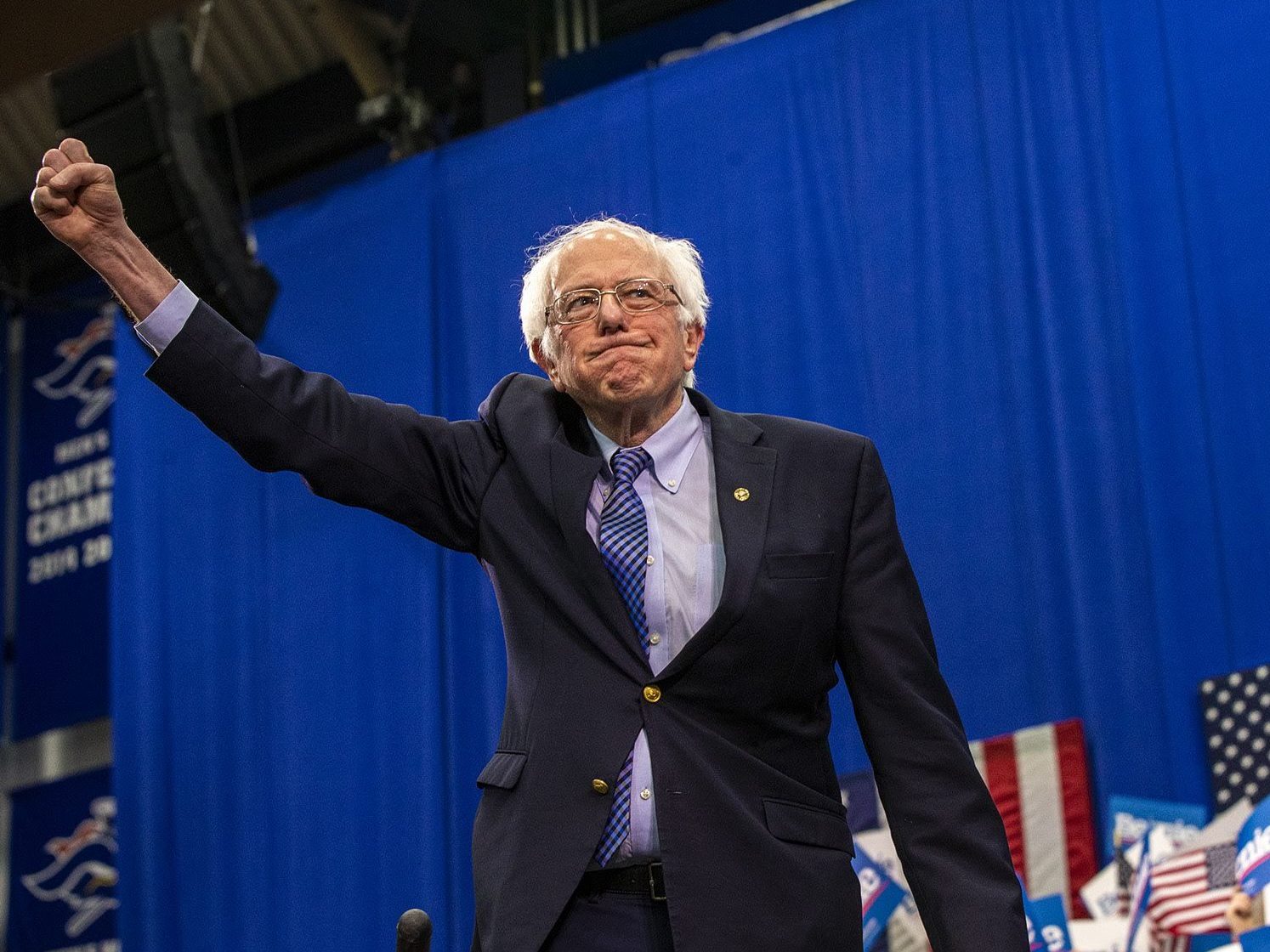 caption: Bernie Sanders raises his fist in victory after the New Hampshire primary. Sanders is in the pole position for the Democratic nomination.