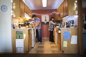caption: Deborah Bartlett, shown here in her kitchen with Ponch Hartley, cooks meals in her South Lake Union home so she's not tempted to patronize her neighborhod's pricey restaurants.