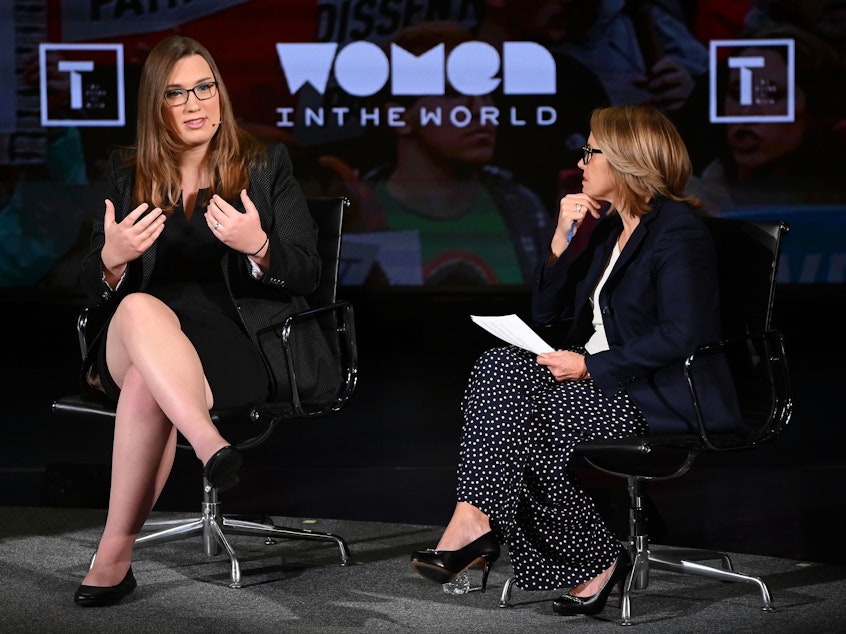 caption: Sarah McBride and Katie Couric speak onstage during the Women In The World summit on April 11, 2019 in New York City.