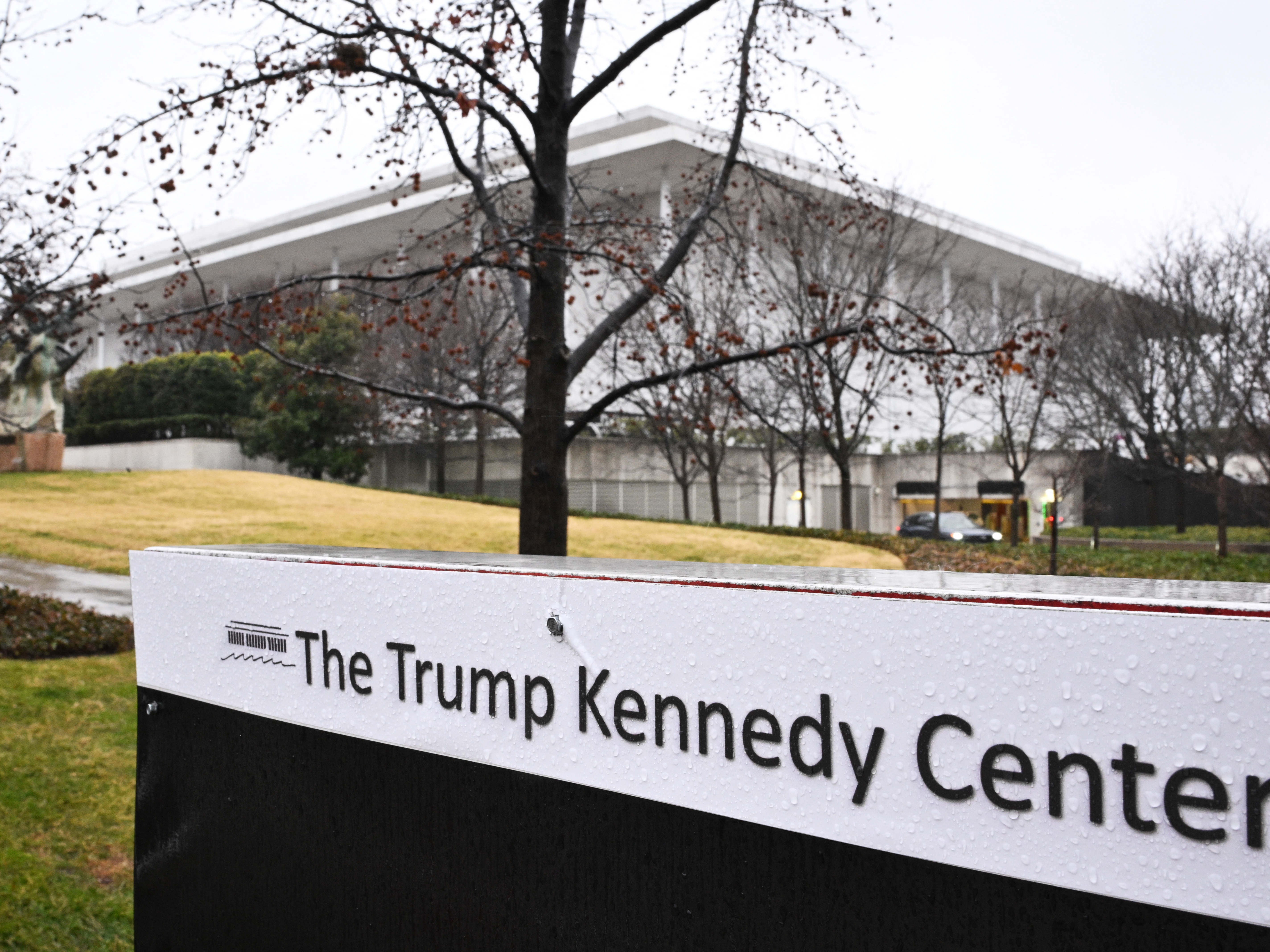 caption: A general view shows the Kennedy Center in Washington, DC on January 10, 2026. Two lawsuits are calling to halt the closure of the Center for renovations. Rep. Joyce Beatty, an ex-officio trustee, is also asking for the removal of President Trump's name from the Center, an act that was not approved by Congress. <br>Since the name change, artists have cancelled performances and ticket sales have declined.