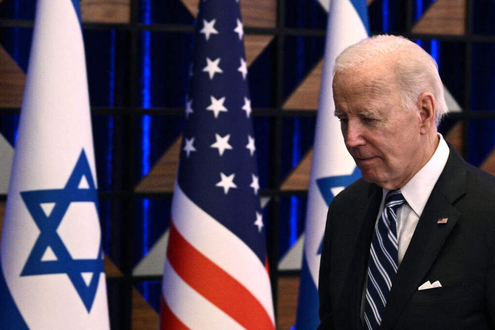 caption: US President Joe Biden leaves the room at the end of a press conference following a solidarity visit to Israel, on October 18, 2023, in Tel Aviv, amid the ongoing battles between Israel and the Palestinian group Hamas in the Gaza Strip. (BRENDAN SMIALOWSKI/AFP via Getty Images)