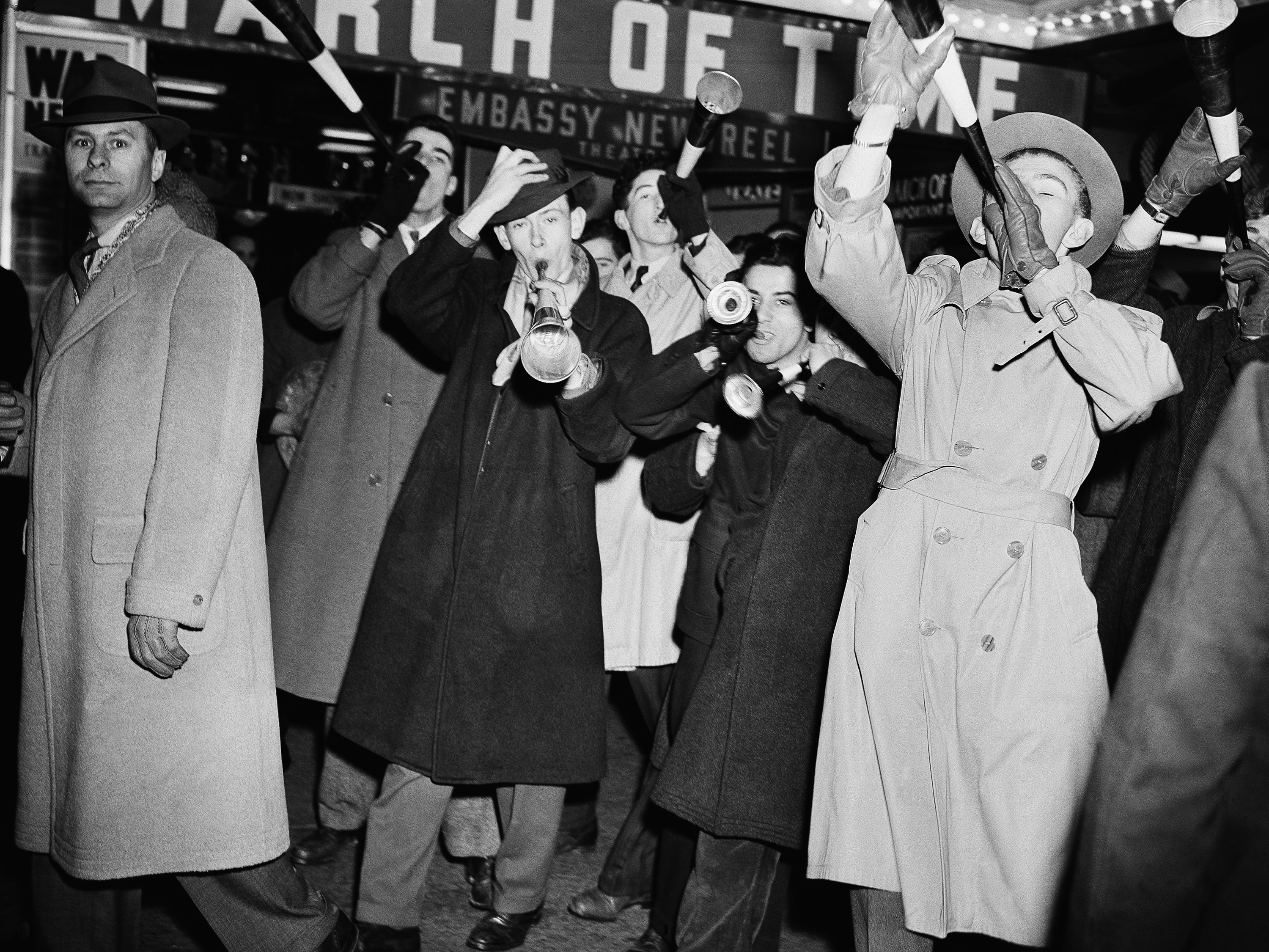 caption: Revelers celebrate the new year on Jan. 1, 1942, in Times Square. Its New Year's Eve ball drop attracts millions of viewers — at home and in the streets of New York City — every year.