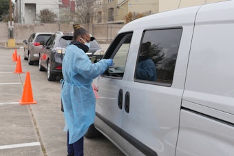 caption: People arrive at a COVID-19 testing station in Houston, Texas, on Jan. 7. Texans were rushing to get tested as the state experienced an unprecedented spike in infections from the omicron variant.