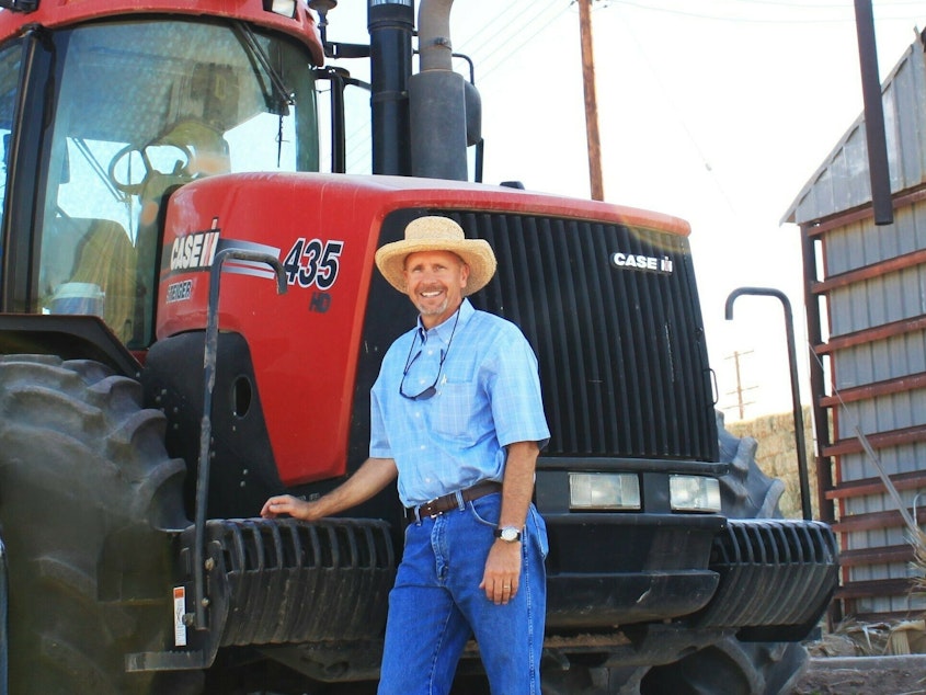 caption: Arizona farmer Craig Alameda stands next to a tractor on his farm near Yuma.