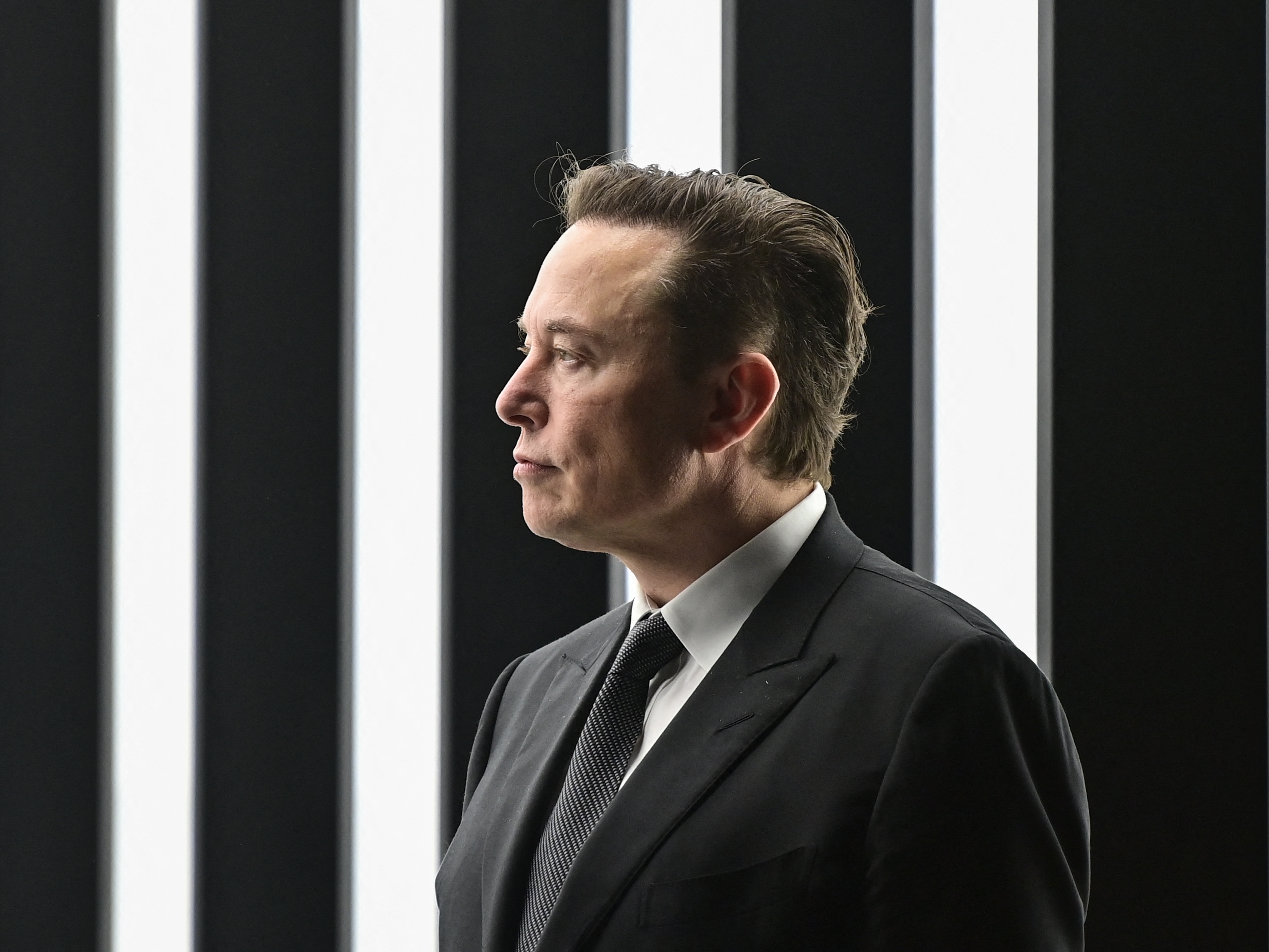 caption: Tesla CEO Elon Musk is pictured as he attends the start of the production at Tesla's "Gigafactory" on March 22, 2022 in Gruenheide, southeast of Berlin.