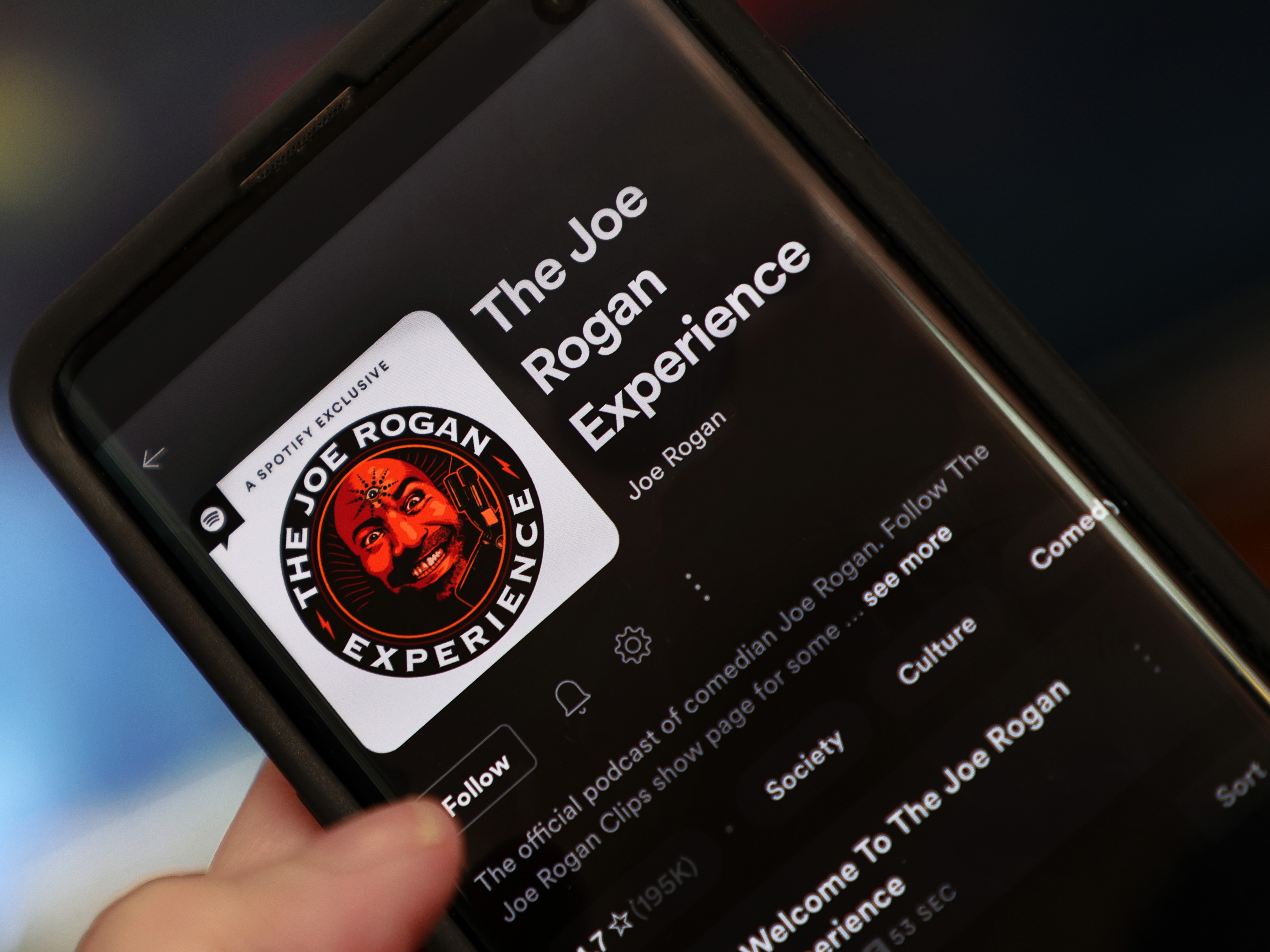 caption: In this file photo illustration, "The Joe Rogan Experience" podcast is viewed on Spotify's mobile app on January 31, 2022 in New York City.