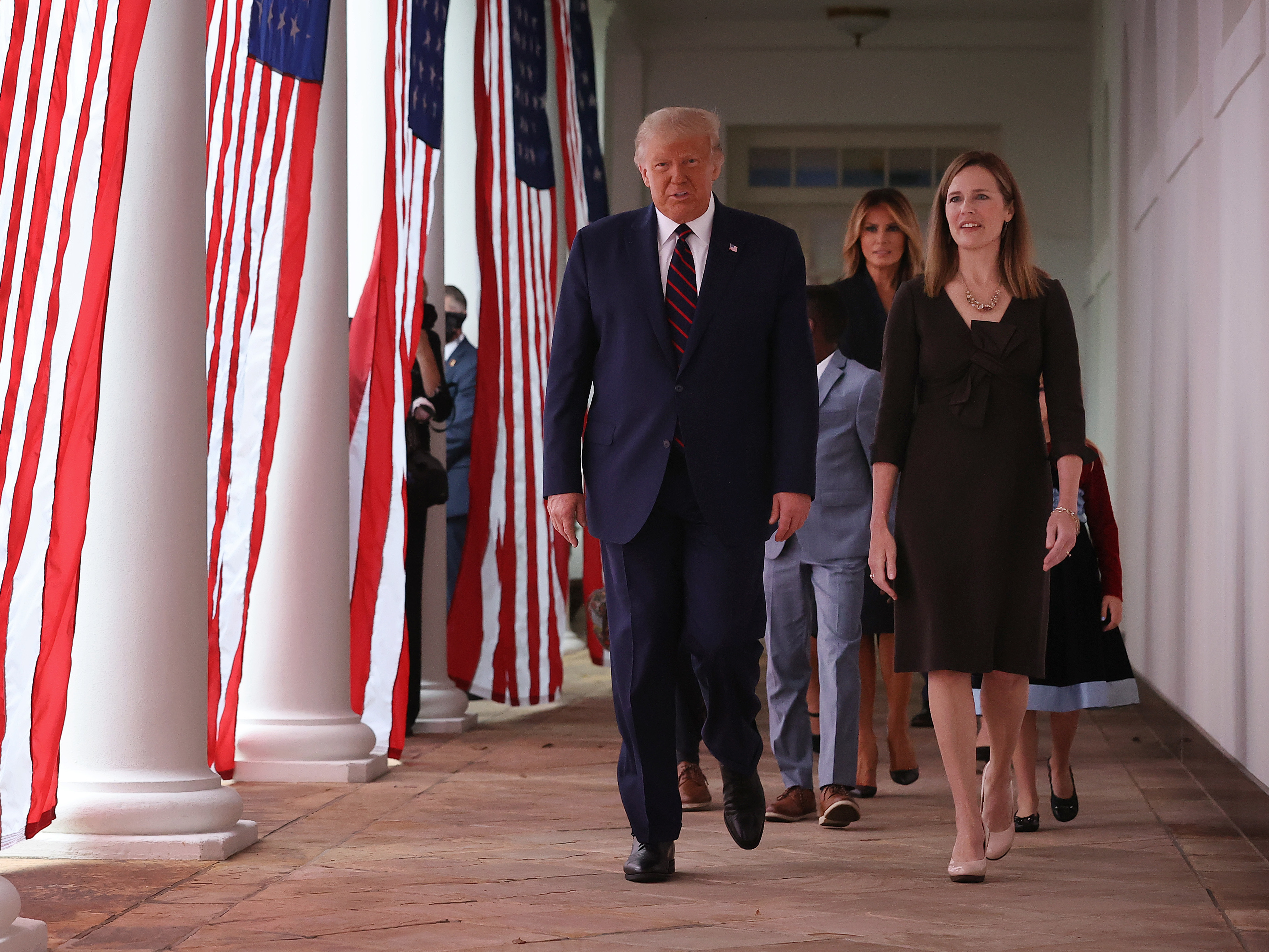 caption: President Trump and Supreme Court nominee Amy Coney Barrett walk along the Rose Garden colonnade on Saturday. The focus on the court just weeks before the election could help energize conservatives in key states.