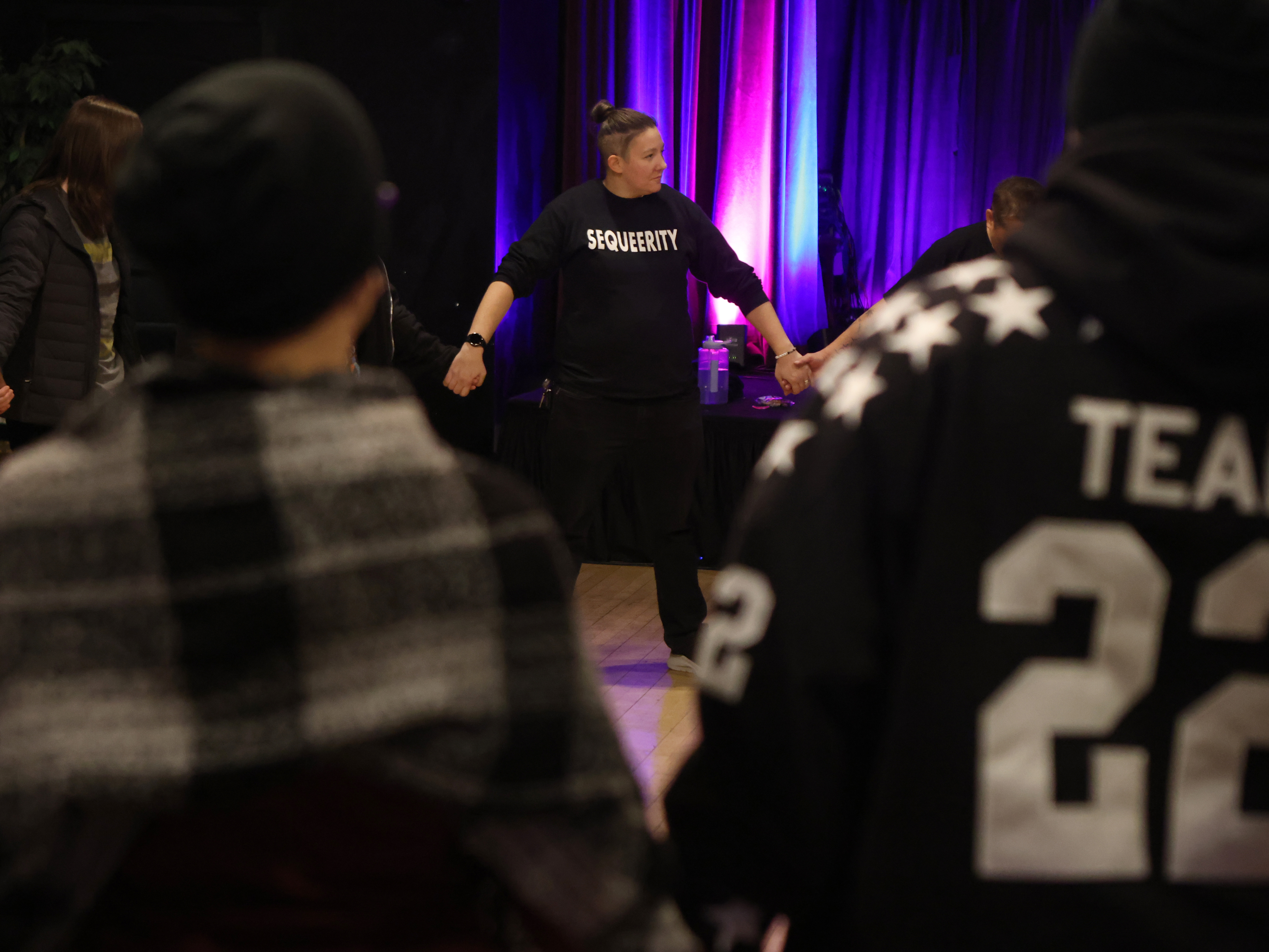 caption: Sam Koshiol-Wright of Sequeerity helps lead a community outreach event in Minneapolis, Minn., Dec. 4.