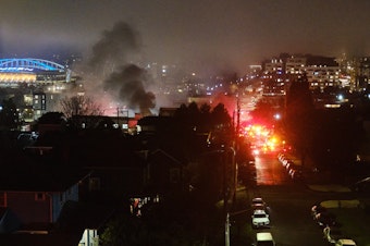 caption: Smoke can be seen coming from the Seattle Betsuin Buddhist Temple on New Year's Eve 