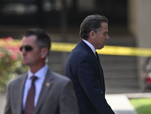 caption: Hunter Biden arrives in J. Caleb Boggs Federal Building to appear in court to plead guilty to two federal misdemeanors for not paying taxes on time, and possessing a gun as a drug user, in Delaware on July 26.