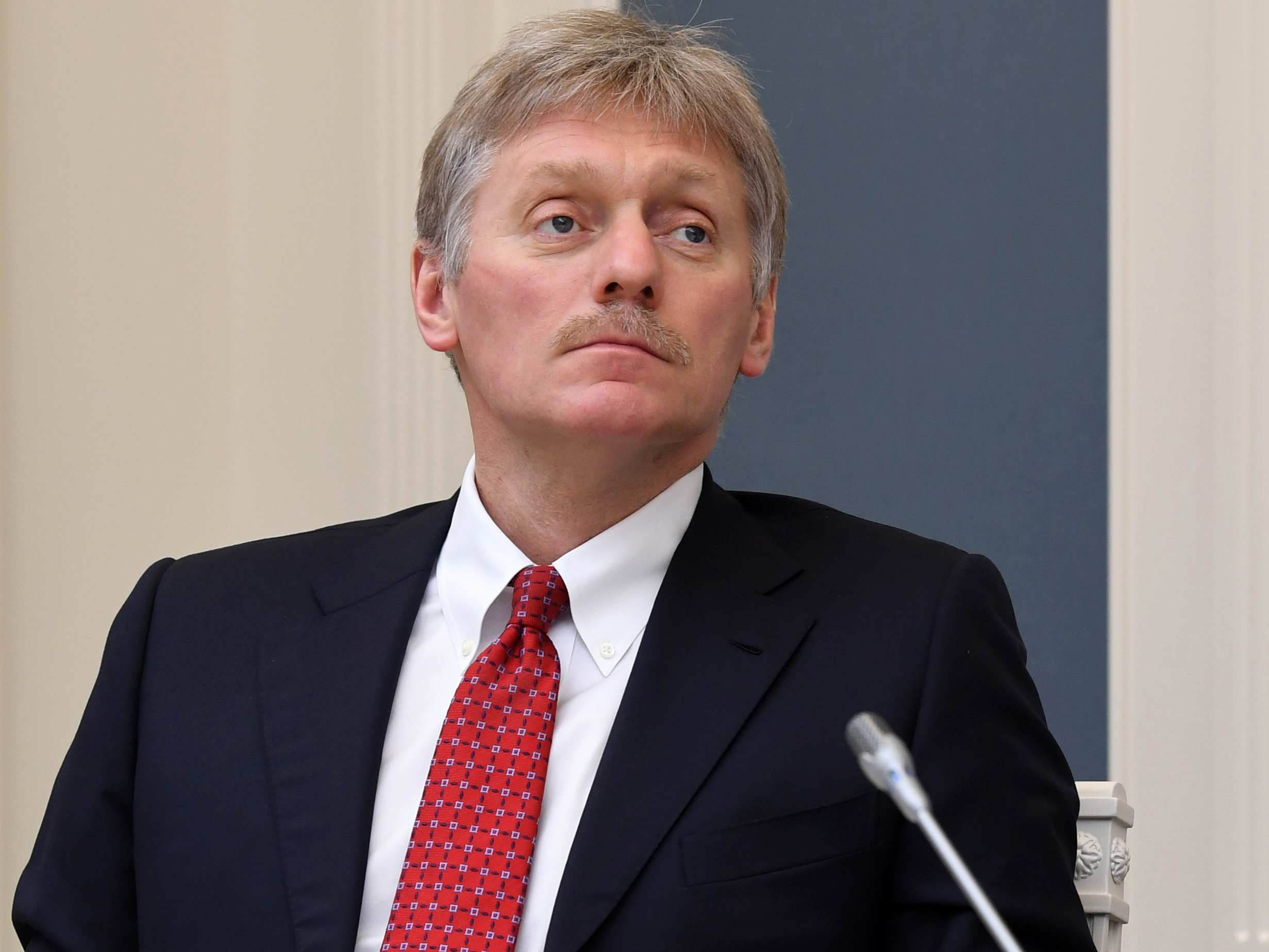 caption: Kremlin spokesman Dmitry Peskov says he is currently hospitalized with COVID-19 — a revelation that came as Russia hopes to emerge from a shutdown despite a spike in new cases. Peskov is seen here during a video conference with Russian President Vladimir Putin in Moscow on April 14.