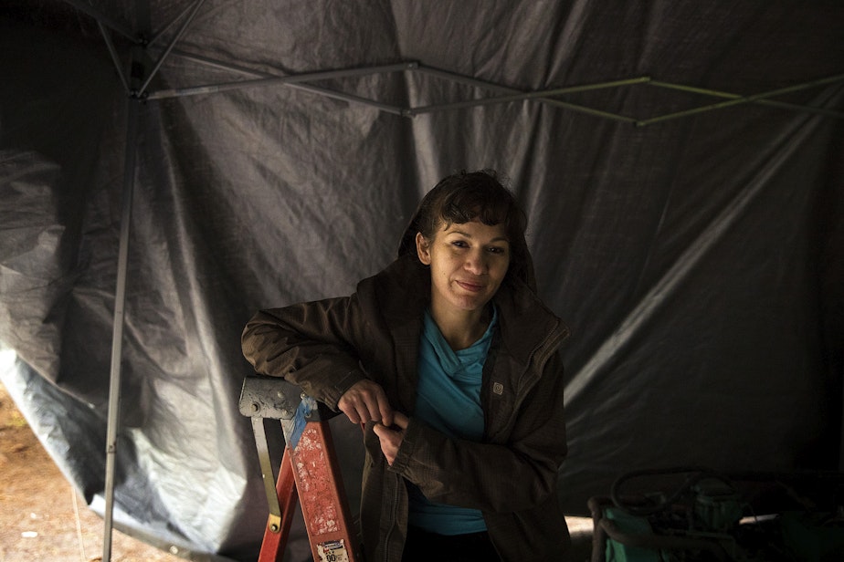 caption: Starshaw Dawn Burnam is portrayed near her RV as the city of Seattle removed unhoused people and their belongings from Woodland Park on Tuesday, May 10, 2022, in Seattle. In order to move their RV, Burnam and her partner needed fuel. 
