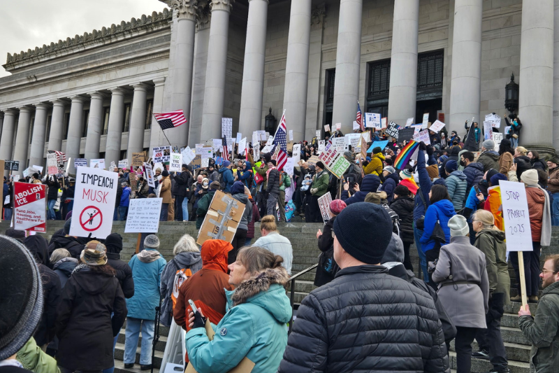 caption: Protesters opposing the Trump administration gather at the Washington state Capitol in Olympia on Wednesday, Feb. 5, 2025.