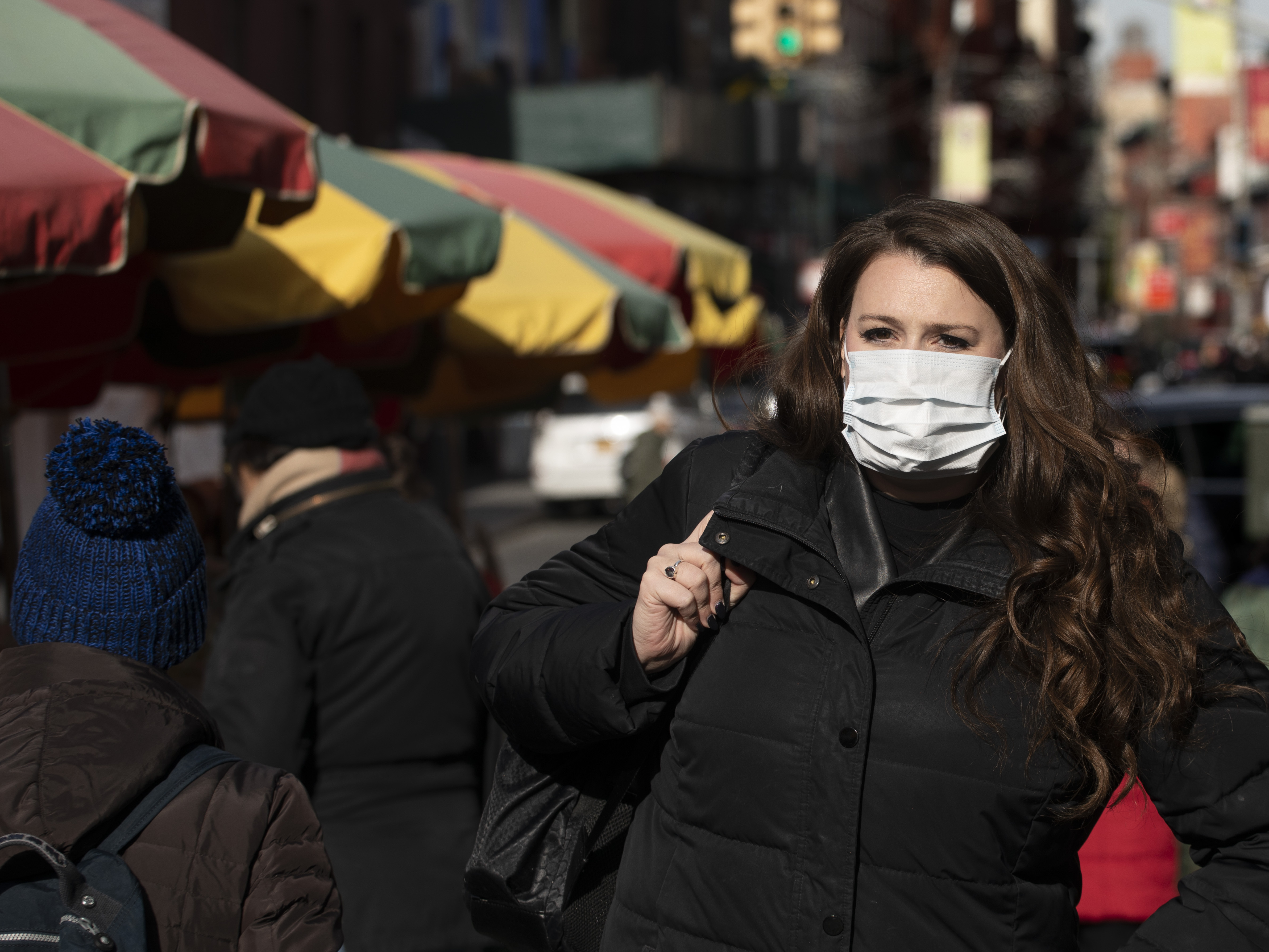 caption: A woman, who declined to give her name, wears a mask in New York out of concern for the newly emerged coronavirus.