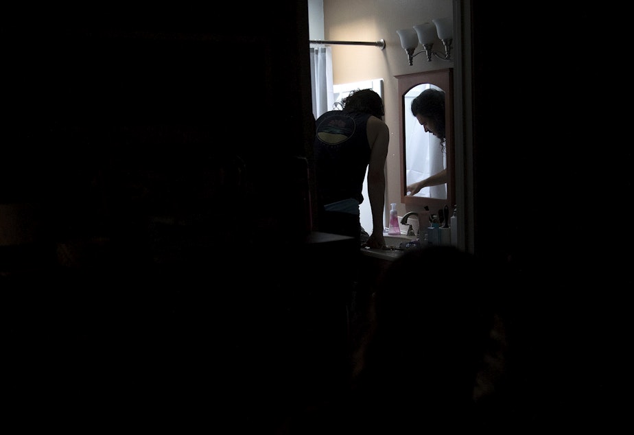 caption: Jake Black checks on his wife, Hope Black, as she labors in the bathtub at 5:27 a.m., on Friday, May 28, 2020, at their home on Vashon Island. 