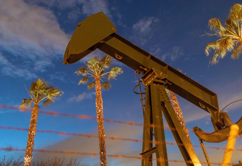 caption: Pump jacks draw crude oil near Long Beach, Calif., on March 9. A U.S. crude oil benchmark has hit 34-year lows.