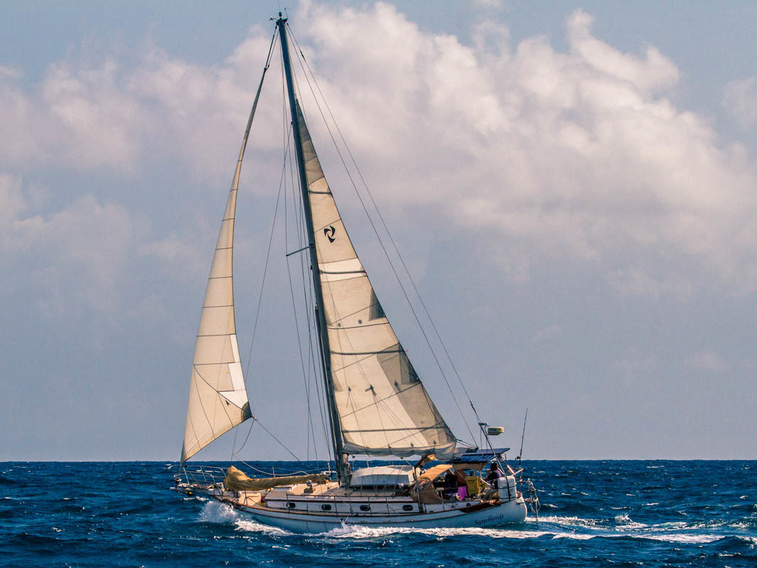 caption: Author Scott Neuman's sailboat, Symbiosis, on passage between St. Lucia and Martinique in 2017.