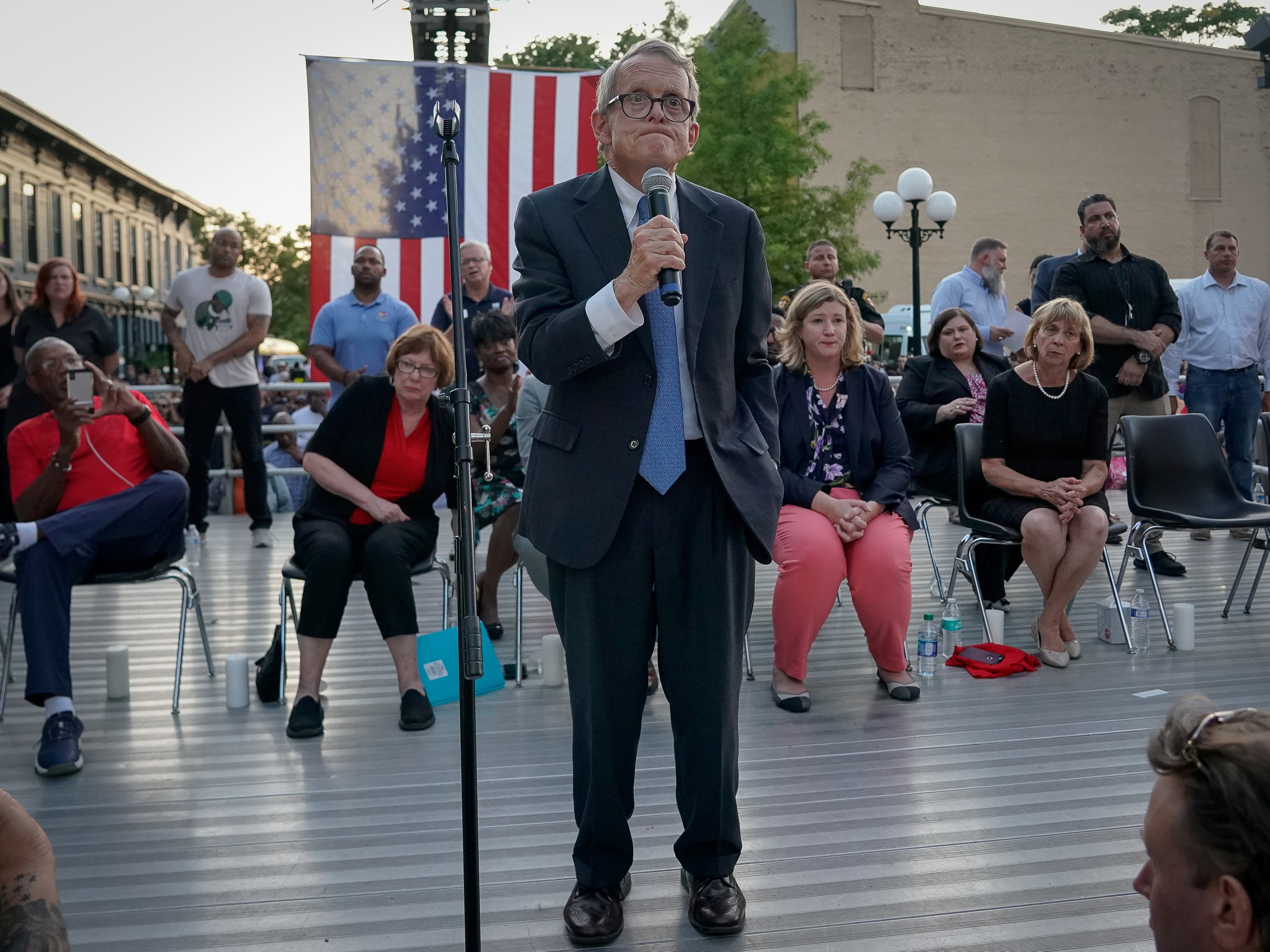 caption: Ohio Gov. Mike DeWine reacts as vigil attendees shout "Do Something!" during his speech in the wake of a deadly mass shooting in Dayton.