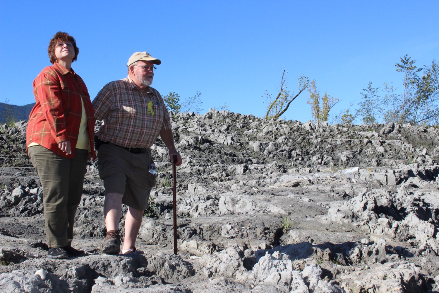 caption: Gail and Ron Thompson return to the site of the devastating mudslide for the first time since it took out their home and killed many of their neighbors.