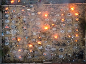 caption: Victims of COVID-19 are cremated in funeral pyres this week in New Delhi. Scientists says the real death toll and number of infections are likely much higher than what the Indian government is reporting.
