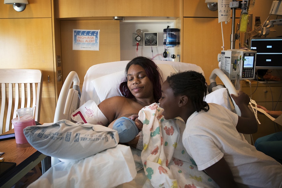caption: Tiffany Hicks and Mariah Hicks, 7, admire the newest addition to their family, Elijah Dayshawn Lindley, on Tuesday, August 29, 2017, at Swedish First Hill Birth Center in Seattle. 