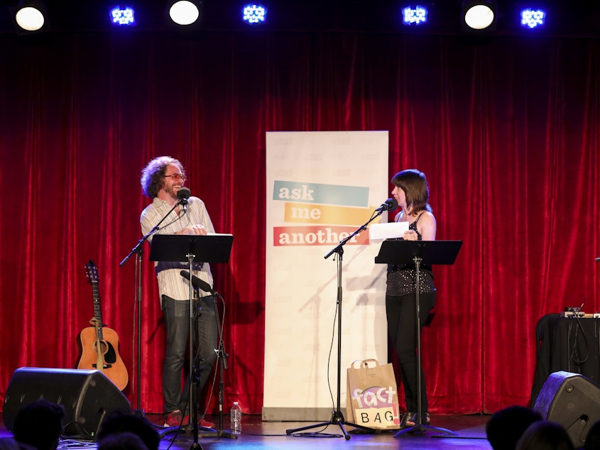 caption: In a game called Fact Bag, Ophira Eisenberg reads facts from a bag.