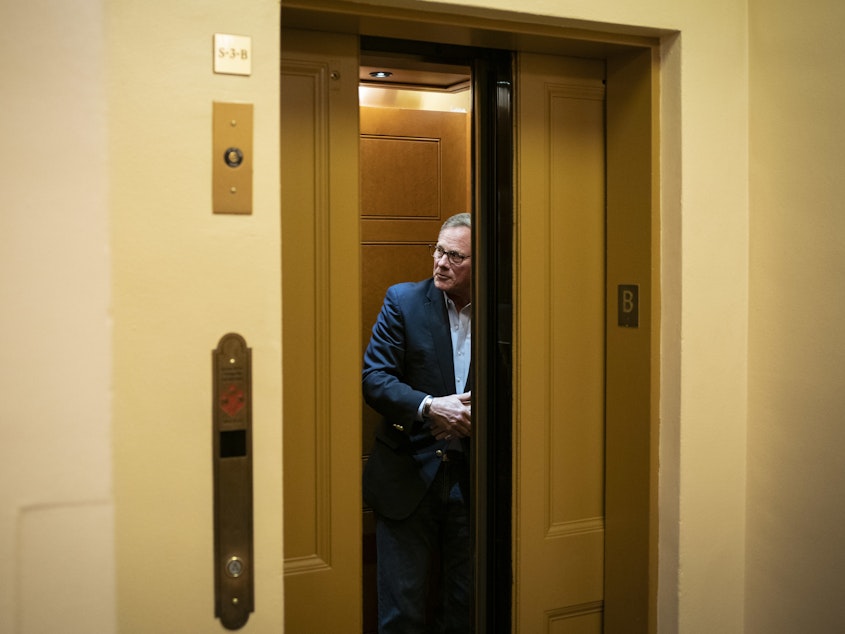 caption: Sen. Richard Burr, a Republican from North Carolina, stands in an elevator as he arrives for a vote at the U.S. Capitol on March 25, 2020.