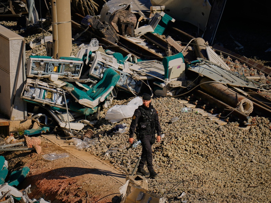 caption: Guardia Civil officers collect evidence Tuesday next to the wreckage of train cars involved in a collision in Adamuz in southern Spain.