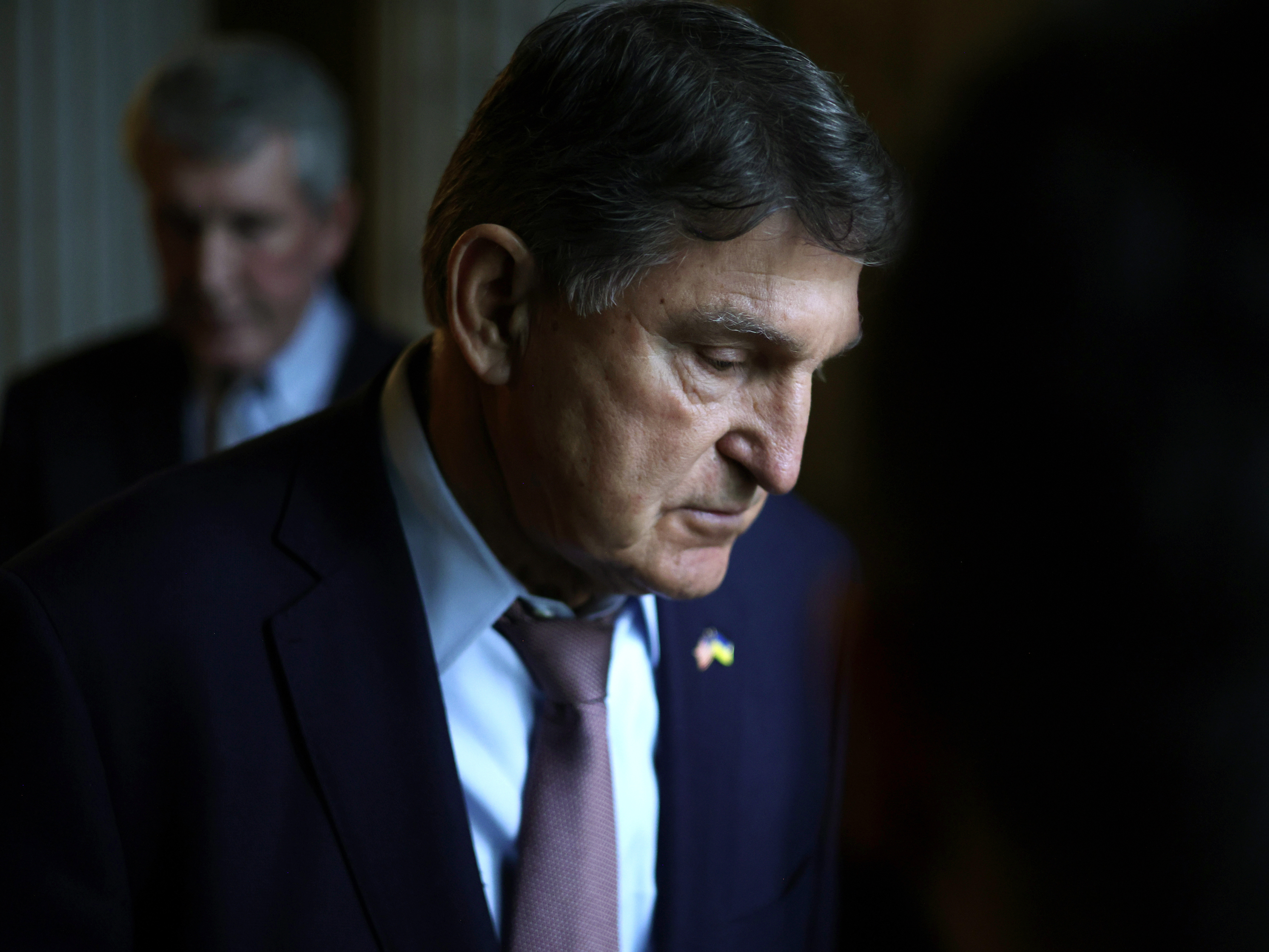 caption: Sen. Joe Manchin, D-W.Va., leaves the Senate chamber after a live quorum call at the U.S. Capitol this week.