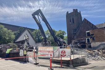 caption: The historic University Temple United Methodist Church on 15th Avenue in Seattle's University District was demolished on June 18, 2021.