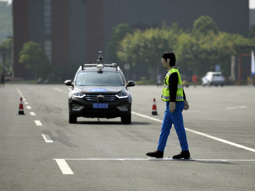 caption: An unmanned automobile competes in the i-VISTA (Intelligent Vehicle Integrated Systems Test Area) Autonomous Driving Challenge on August 18 in Chongqing, China.