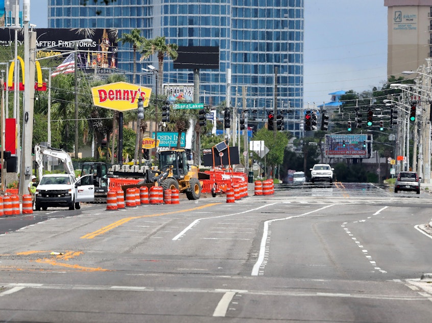 caption: A normally busy intersection in  Orlando is nearly deserted on April 6. Restaurants and retail stores in most of Florida will be allowed to open at limited capacity on Monday.