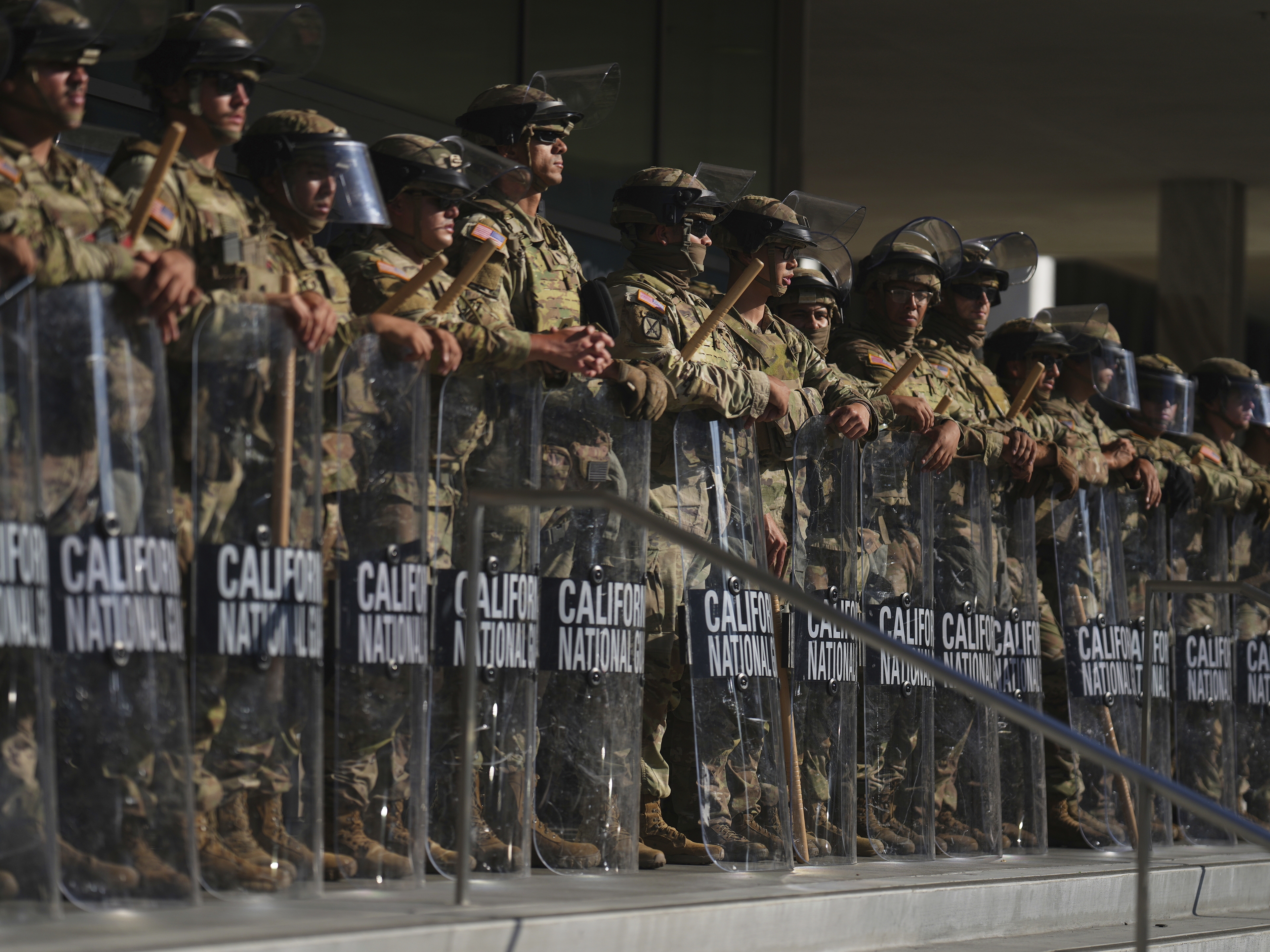 caption: FILE - California National Guard are positioned at the Federal Building, June 10, 2025, in downtown Los Angeles.