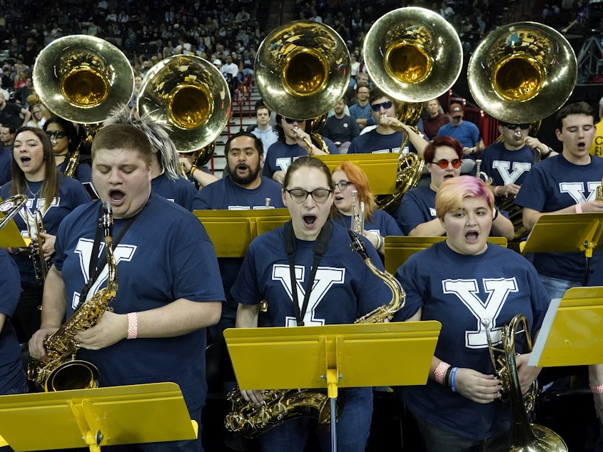 caption: The University of Idaho Marching Band, wearing Yale T-shirts, performs at the NCAA Tournament game between Yale and San Diego State in Spokane, Wash., on Sunday. The band has been honored in Connecticut for filling in as Bulldogs.