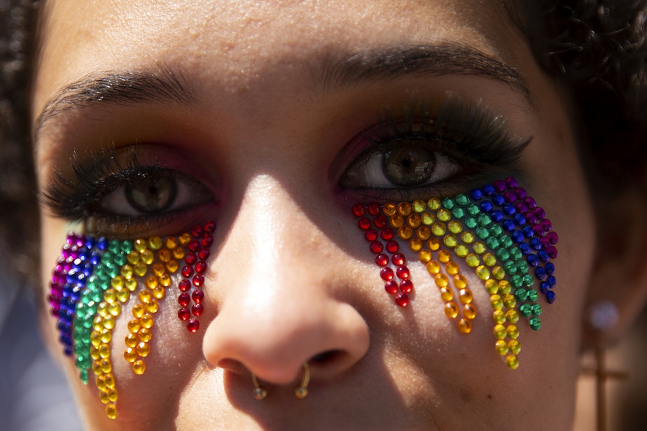 caption: Jackie Easton, 19, is portrayed during the Seattle Pride Parade on Sunday, June 25, 2023, in downtown Seattle. 