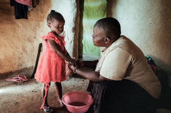caption: Isabela Oside, 45, washes hands of her daughter Faith, 3, who completed doses through the worlds first malaria vaccine. Malaria is one of the preventable diseases that contributes to worldwide child mortality.