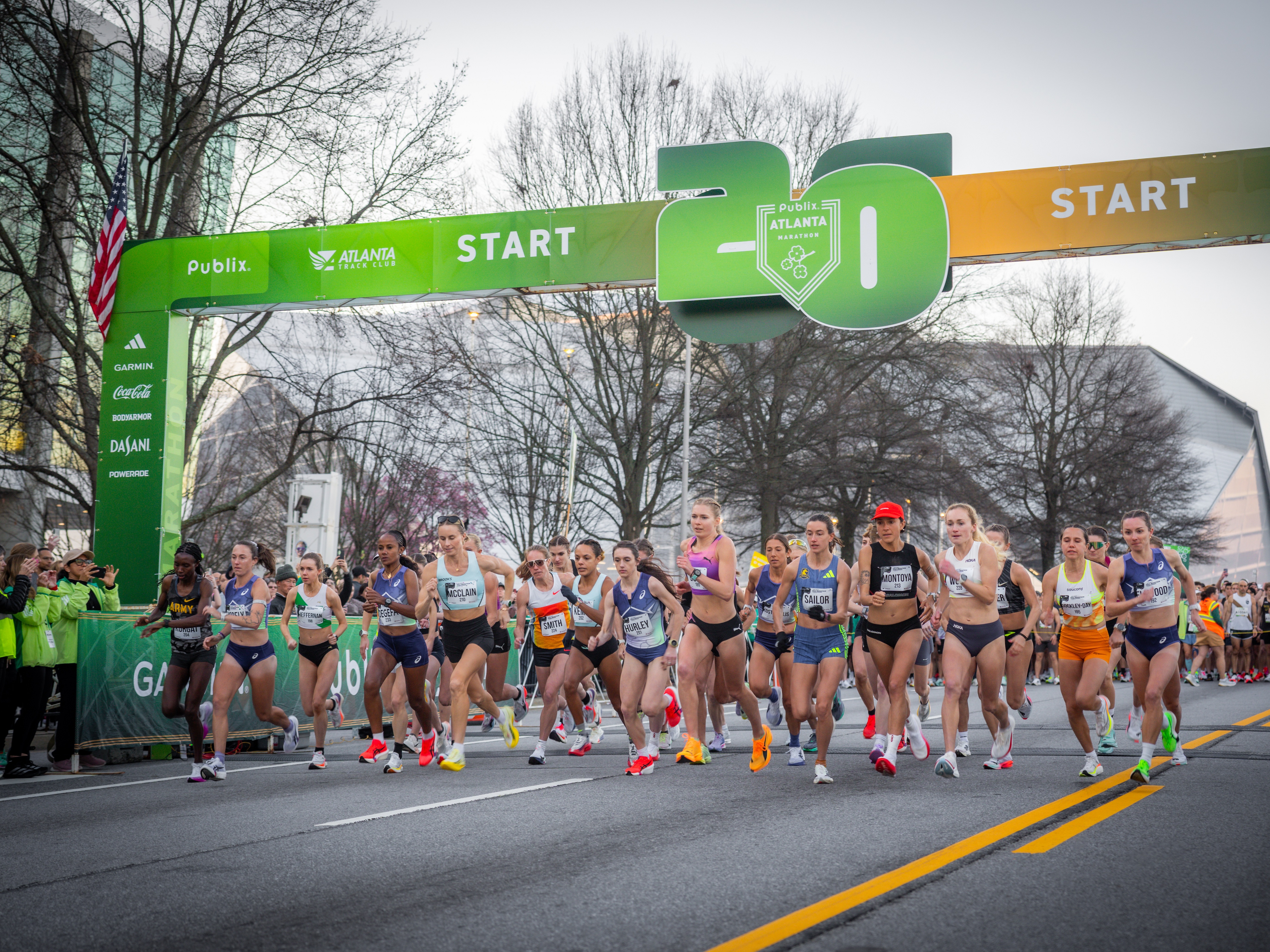 caption: Elite female distance runners take off at the start of the Atlanta Half Marathon on March 1. Jess McClain, middle left, led much of the race before an official car led her off course.