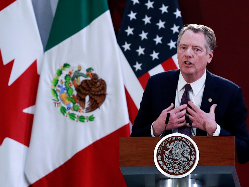 caption: U.S. Trade Representative Robert Lighthizer speaks Dec. 10 in Mexico City during an event to sign an updated trade agreement between the U.S., Canada and Mexico. It was just one development in a week that exposed deep cracks in the global trading system.