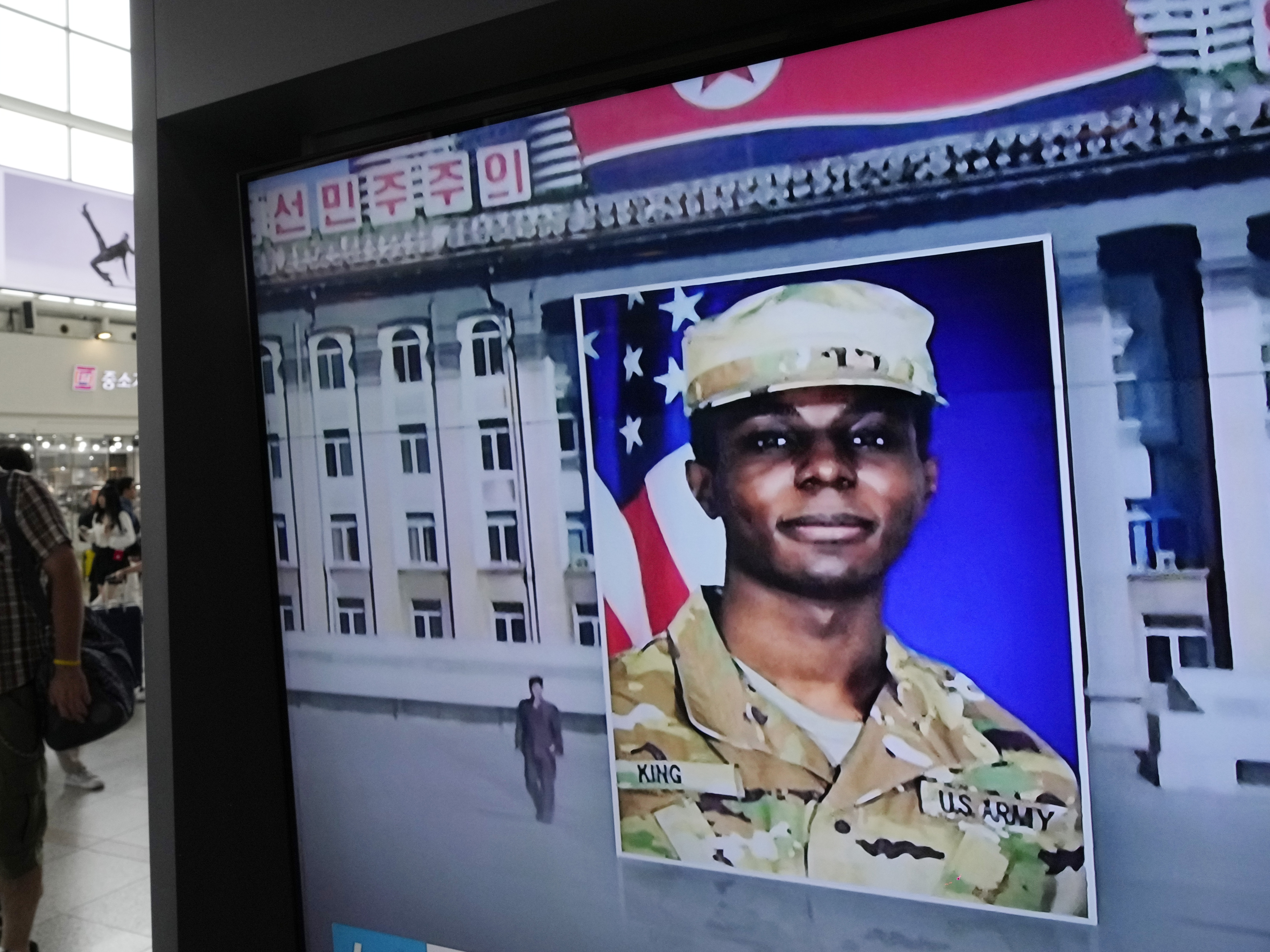 caption: A television screen shows a file image of Pvt. Travis King during a news program at the Seoul Railway Station in Seoul, South Korea, on Aug. 16, 2023.