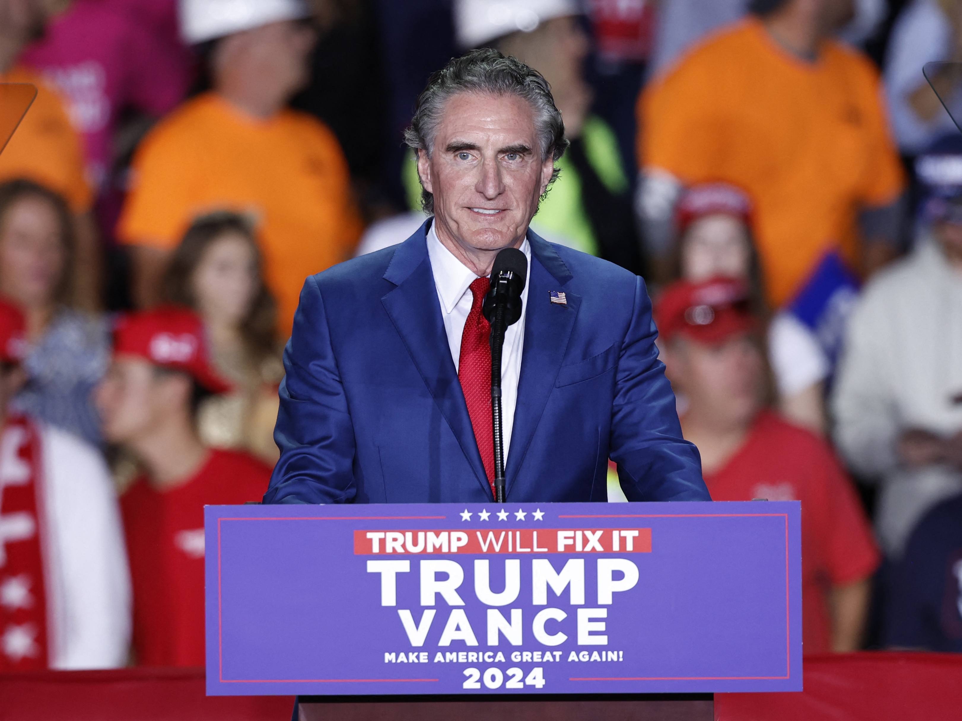 caption: North Dakota Gov. Doug Burgum, pictured at a campaign rally early this month in Michigan, would play a key role in pushing President-leect Donald Trump's agenda to increase oil, gas and coal production on public lands if he is confirmed as secretary of the Interior Department.