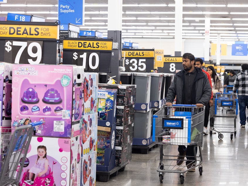 caption: Shoppers walk the aisles of Walmart for Black Friday deals in Dunwoody, Georgia. Walmart opened at 6am on Black Friday for shoppers.