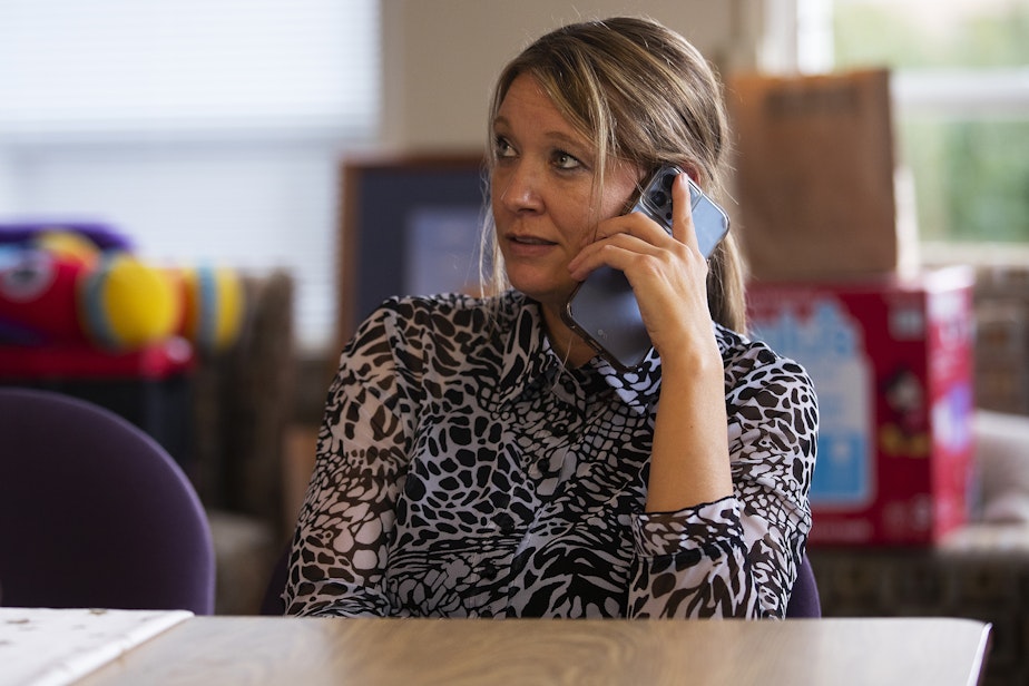 caption: Toni Gardner, lead case manager at Sound Pathways, talks with a mother on her caseload while working on Friday, September 23, 2022, in Everett.