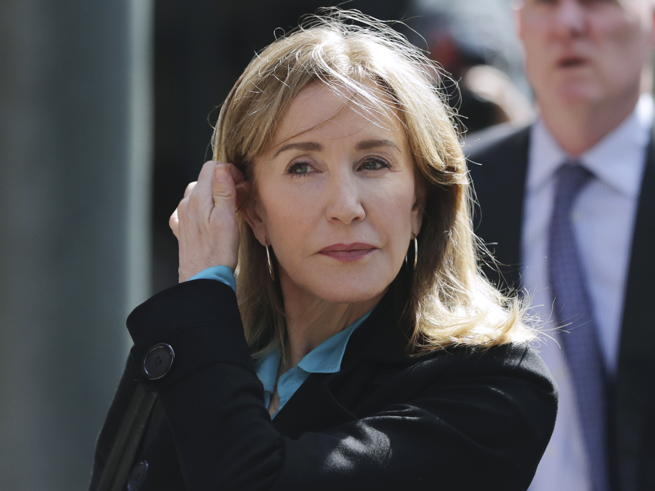 caption: Federal prosecutors say that one coach and 13 parents, including actress Felicity Huffman, will plead guilty to fraud charges in the college admissions scandal. Huffman is seen here arriving  at federal court in Boston last week.